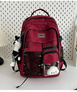 Detailed view of utility burgundy school backpack with multi pockets and clear front pocket.