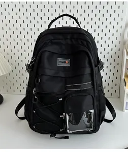 Detail shot of a black utility backpack featuring multiple pockets, transparent front window and straps.