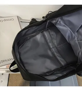 Close-up view of the black backpack interior showing grey lining and organized compartments.
