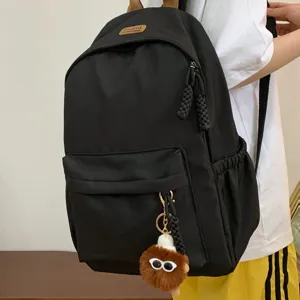 Stylish black casual school backpack for students with cute furry sunglasses pendant bag.