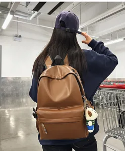 Brown PU leather backpack for women, waterproof casual school bookbag and computer daypack.