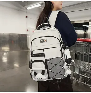 Large capacity student backpack with multi pockets and cute pendant for teenage girls.