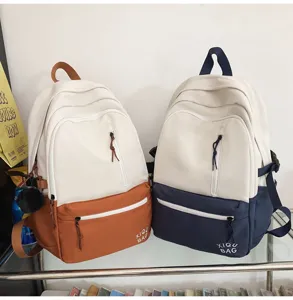 Stylish color block canvas backpack for students, casual daily laptop school bag campus use.