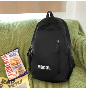 Black large capacity school backpack for students with front zipper pocket and letters.