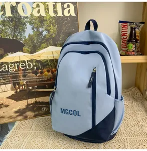 Detail view of the light blue and dark blue contrast color backpack with front letter print.