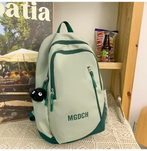 Green large capacity school backpack detail with pockets and cute pendant for daily.