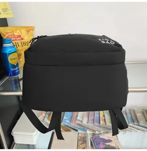 Detailed view of casual black backpack on shelf with props, minimalist design style.