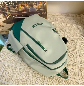 Detailed view of the mint green large capacity school backpack with dual shoulder straps.
