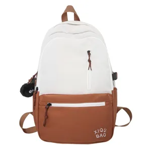 Two-tone canvas backpack for school and daily casual use with front pocket and cute charm.