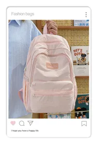 Pink casual minimalist student backpack, detailed view of soft nylon and front pocket.