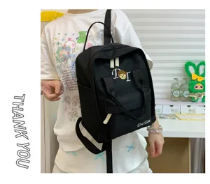 Black canvas casual school backpack for women, featuring front pocket, top handle and embroidery.