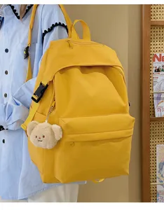 Yellow nylon casual backpack for women, daily school bookbag with cute bear pendant.
