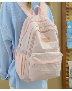 Casual pink backpack for women, lightweight multi-pocket school bag for daily use and travel.