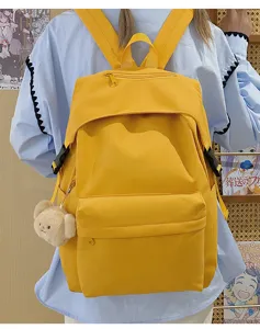 Casual yellow nylon backpack with cute bear pendant, stylish daily school bag for students.