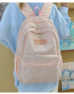 Lightweight pink school backpack for women, casual daily simple daypack with multiple pockets.