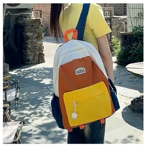 Colorful block children backpack detail view showing front pocket, patches and durable fabric.