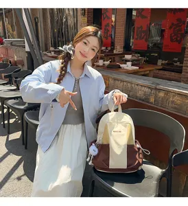 Canvas backpack with color block design, casual daypack for school travel and daily outdoor use.