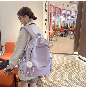 Casual light purple school backpack for women, stylish minimalist daily daypack with cute keychain.