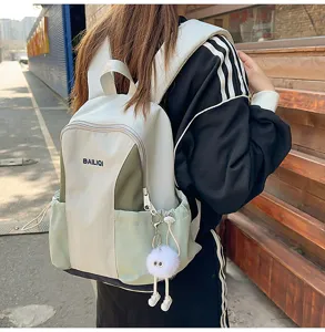 Casual waterproof backpack detail shot showing contrast color design and side drawstring pockets.
