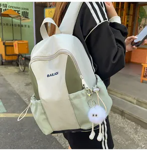 Lightweight casual backpack with cute fluffy pendant, dual color design and multiple pockets.