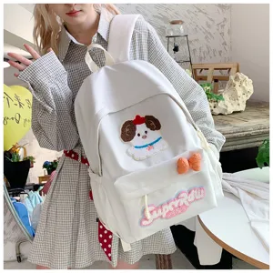 Cute white canvas backpack featuring adorable dog patch and bow design, detailed view.