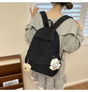 Japanese style casual campus backpack for women, lightweight nylon school bag with cute pendants.