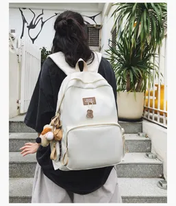 Minimalist white canvas student backpack detail, casual large capacity campus bookbag.