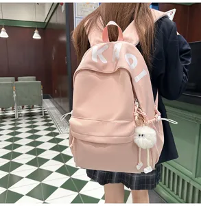 Cute pink canvas backpack for teen girls, large capacity school bookbag with cute plush pendant.
