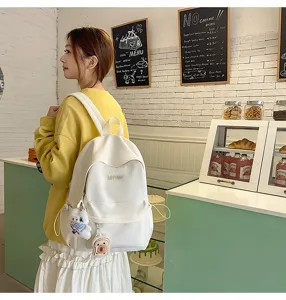 Casual canvas school backpack for women, lightweight travel daypack with cute pendants.