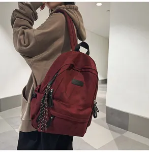 Detail view of large capacity vintage canvas backpack with multi pockets and braided pendant.