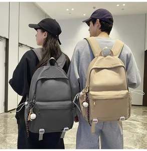 Casual canvas school backpack for students, large capacity solid color daypack with side pockets.