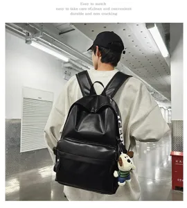 Detail view of the black PU leather backpack worn by model, showing daily wearing style.