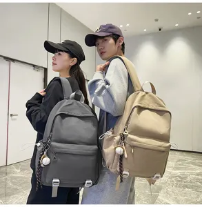 Large capacity student backpack, versatile casual solid color school bag for daily use.