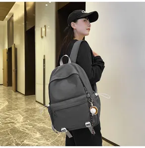 Large capacity grey backpack casual school bookbag for women men durable everyday travel bag.