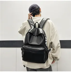 Black PU leather backpack detail view, featuring minimalist style and side letter print.