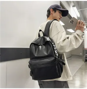 Stylish black PU leather backpack for men and women, waterproof daily school bookbag.