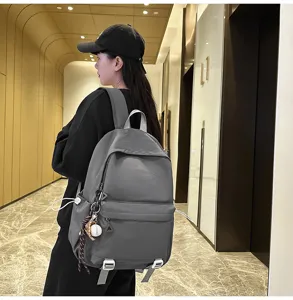 Grey campus backpack detail, multi-compartment storage, durable fabric, casual daily style bag.