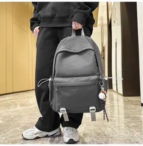 Detail view of the large capacity casual backpack with side drawstrings and front pocket design.