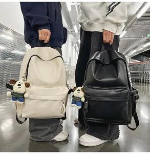 Casual PU leather waterproof backpack for women, stylish student laptop bag with cute dog pendant.
