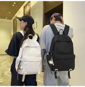 Detail view of casual backpacks worn by models, featuring large capacity for daily use.