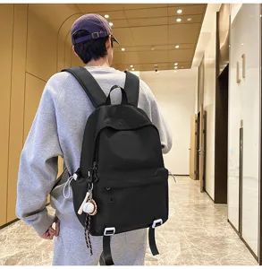 Classic black backpack for men and women, large capacity casual school bag for daily use.