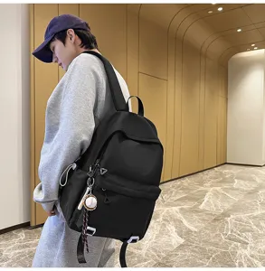 Casual black backpack for men and women, large capacity minimalist school bookbag.
