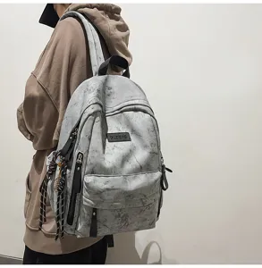 Detailed view of grey marble pattern casual backpack, large capacity school bag design.