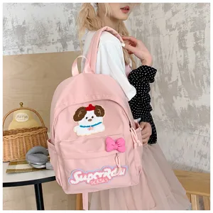 Pink cute school backpack with cartoon dog embroidery and bow for students daily use.