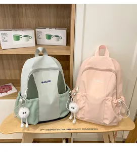 Casual waterproof school backpack with front pocket and cute plush pendant for daily student use
