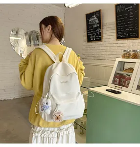 Casual Japanese style campus school backpack for girls, lightweight travel bag with cute pendants.