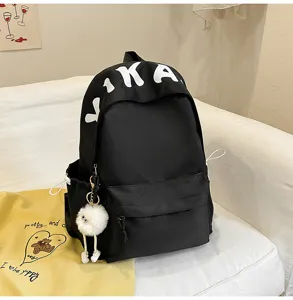 Black large capacity backpack for women casual daily school bookbag with cute plush pendant.