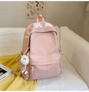 Large capacity pink school backpack, casual daily canvas bookbag with cute plush pendant for girls.