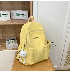 Casual waterproof yellow school backpack for women, large capacity daypack for students.