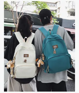 Forest style large capacity campus backpack with cute bear pendant for students daily use.